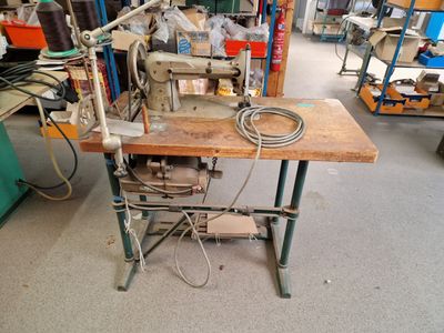 a sewing machine that is sitting on a table in a room