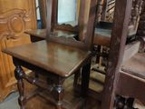 a wooden chair that is next to a wooden chair