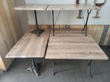 two tables that are sitting next to each other on the floor