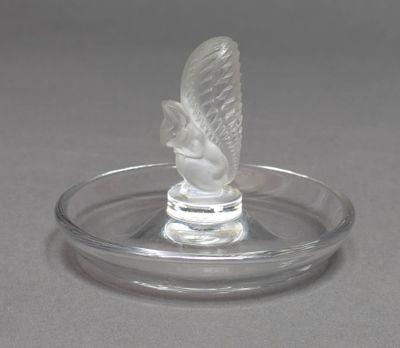 a clear glass object with a bird on top of it