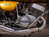 a close up of a yellow motorcycle parked in a garage