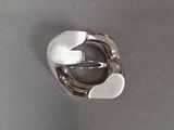 silver ring with two hearts on it sitting on a table