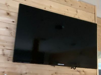 a flat screen tv mounted on the wall in the living room