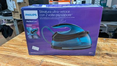 the box of the philips steam iron is on a wooden table