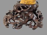 a sculpture of an octopus with a piece of fruit on it ' s head