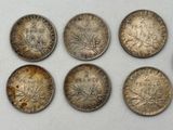 six different types of coins are shown on a white surface