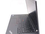 a laptop with a black keyboard on a white surface