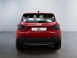 the rear end of a red car in a white room
