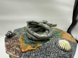 a figurine of a snake on top of a rock