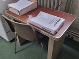 a box of pizza sitting on top of a desk next to a printer