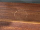 a glass of orange juice on a wooden table