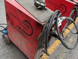 a red machine that is sitting in the parking lot