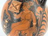 a black and orange vase with a painting on it