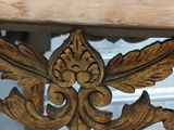 a close up of a wooden table with carvings on it
