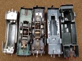 four different types of train cars sitting on the ground