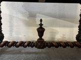 a wooden table with a black top and a brown base