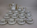 a lot of cups and saucers sitting on a table