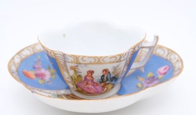 a cup and saucer with a picture of a couple on it