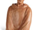 an image of a statue of a man sitting on a white surface
