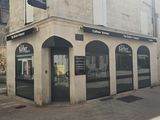 a building that has a barber shop on the side of the street