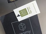 a pillow with a tag on it sitting on a table