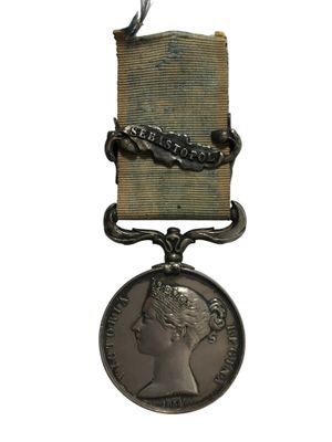 une image d'une médaille entourée d'un ruban sur fond blanc