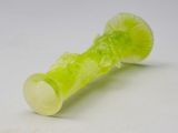 a green glass pipe sitting on top of a white surface