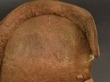 a brown hat with a bow on a black background