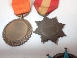 three medals that are on display on a table