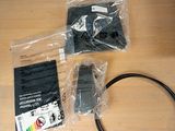 two remote controls and a cable on the table