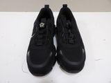 pair of black sneakers on a white surface with a white background