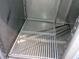 a metal grate in the door of a refrigerator