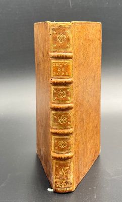 an old book sitting on top of a black table