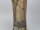 a vase that has a picture of a snowy landscape on it
