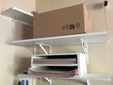 a shelf that has a box on it and a pair of scissors on it