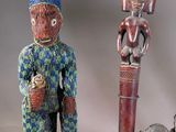 several african figurines are sitting on top of a wooden table