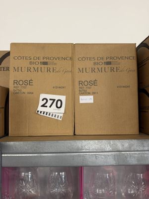 several boxes of wine glasses are stacked on a shelf