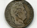 une vieille pièce de monnaie avec un visage d'homme dessus