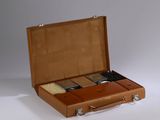 a brown suitcase with a lot of items inside of it