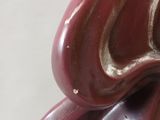 a close up of a figurine of a flower on a table