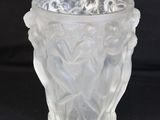 a glass vase with a design on it on a black background