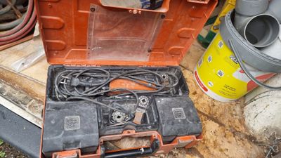 a tool box that is sitting on the ground next to other tools