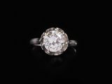 a diamond single - stone ring set in 18k white gold