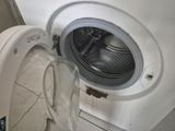 une machine à laver posée dans un coin de la pièce