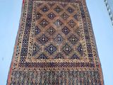 an old persian rug on a white surface
