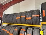 several tires are stacked on a rack in a warehouse