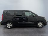 the small black van is parked in a parking lot