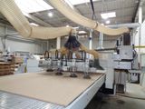a machine that is cutting a piece of wood