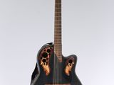 a black acoustic guitar with a wooden neck and a black case