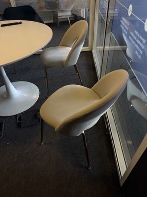 a table and chairs in a room with a glass wall